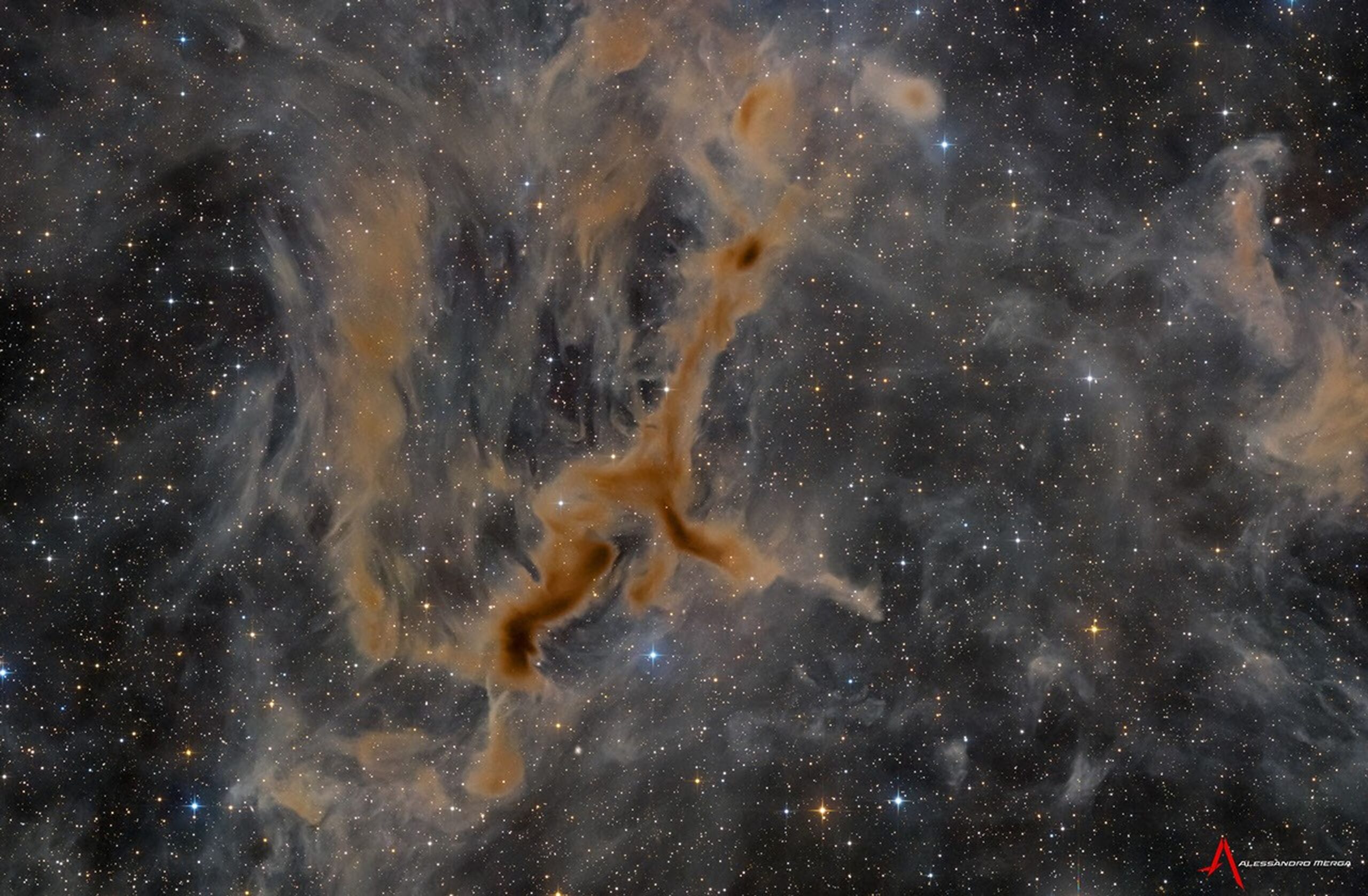 A brown nebula in the shape of a running giraffe is seen in front of a dark field of stars.